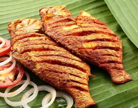 spicy seafood fish fry served on banana leaf,